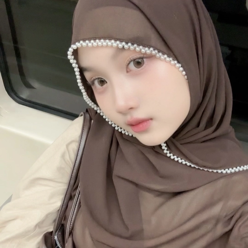 Charming hijab selfie with a soft cheerful expression