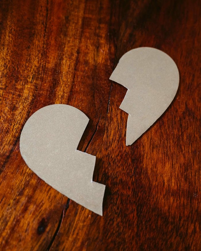 Broken heart art drawn on rustic wooden table surface