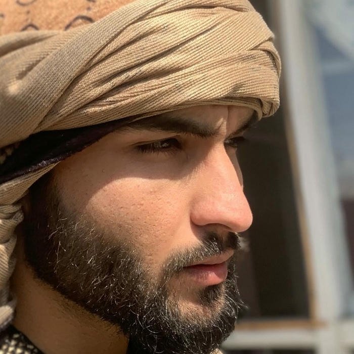 Handsome Arab man with beard looking side profile view