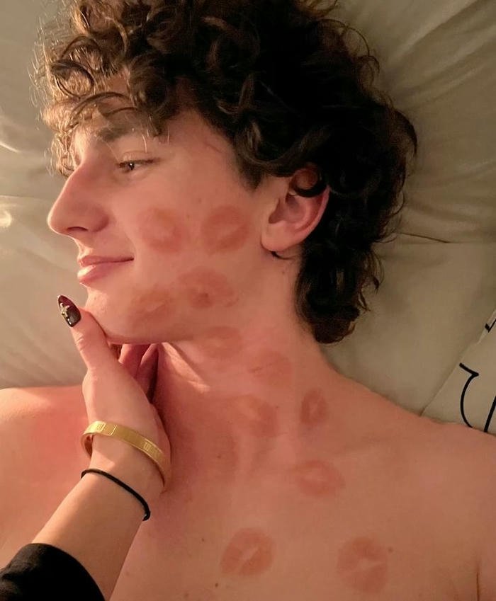 Man face covered red lipstick kisses funny view