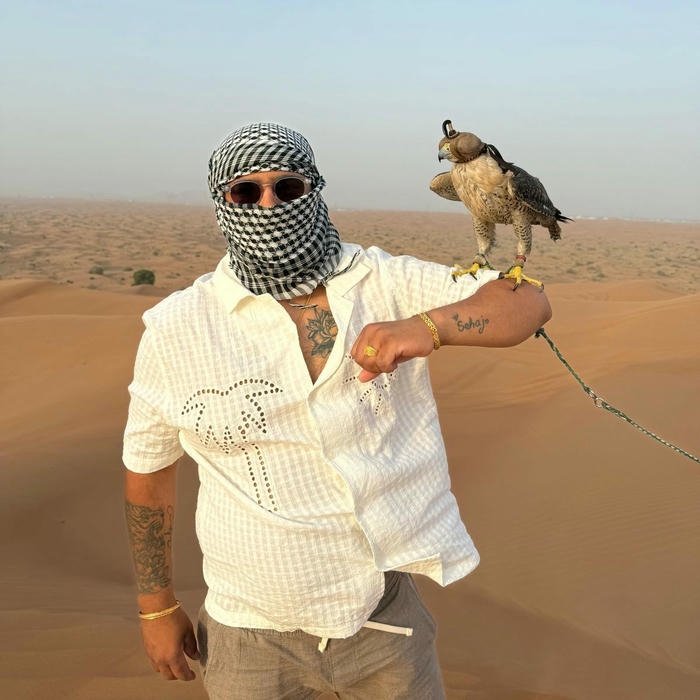 Muslim boys dp man holding falcon bird in desert