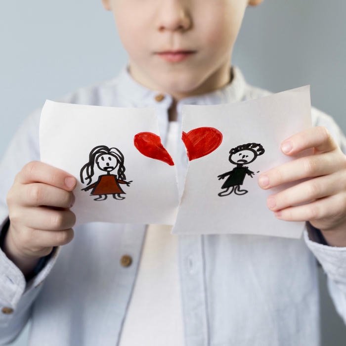 Sad love images person holding torn paper with broken heart drawing