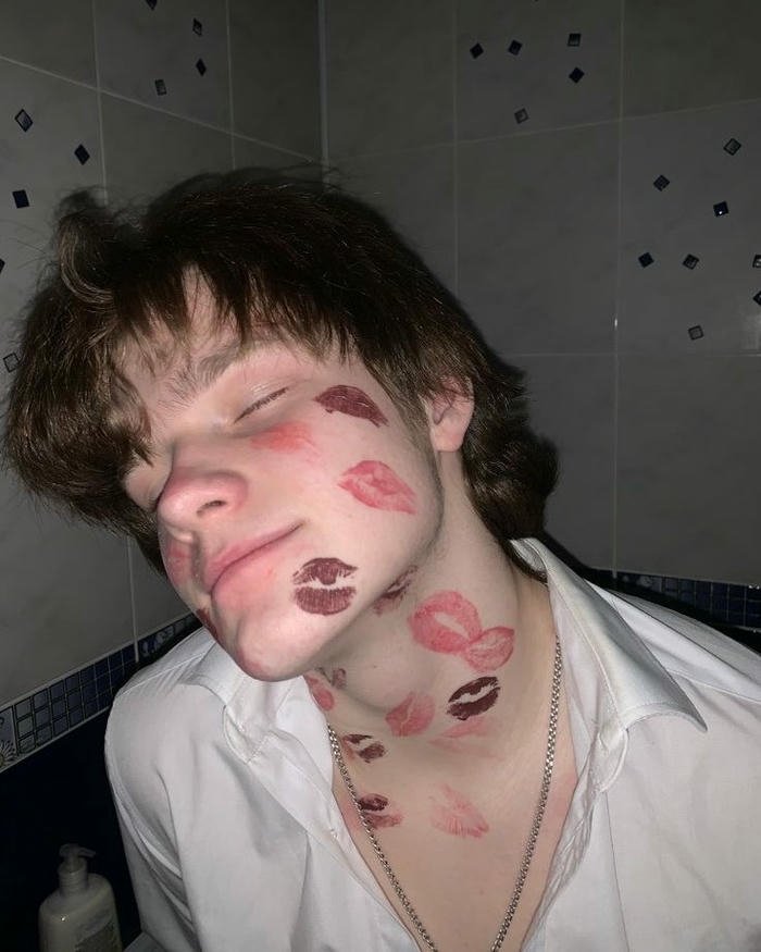 Young man face neck covered lipstick kiss marks