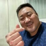 Big man making finger heart cute funny gesture photo