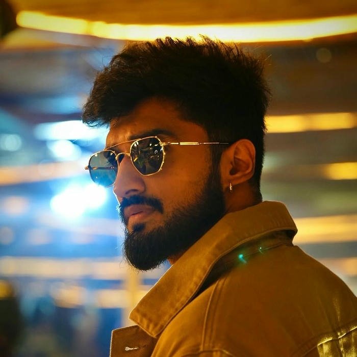 Golden hour portrait man beard sunglasses yellow light