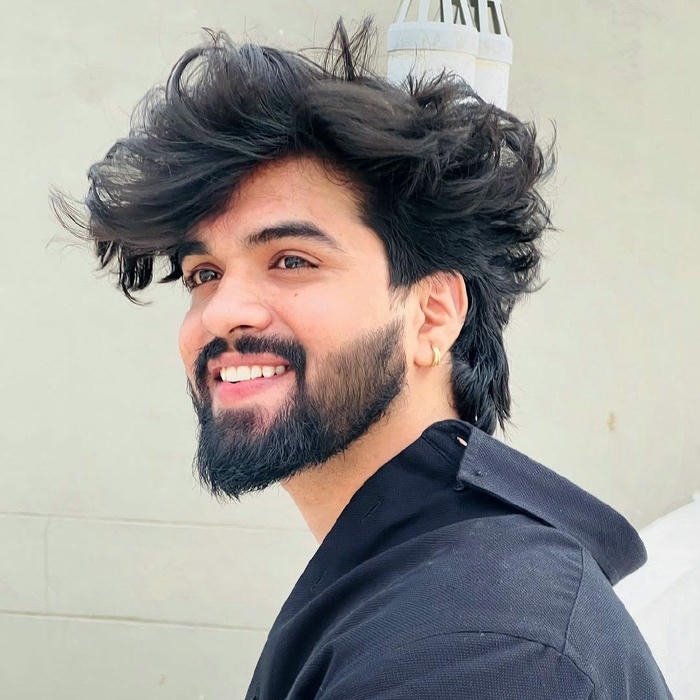 Handsome beard style man smiling side profile close up