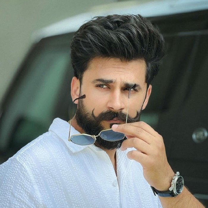 Handsome man biting sunglasses handle wearing white shirt