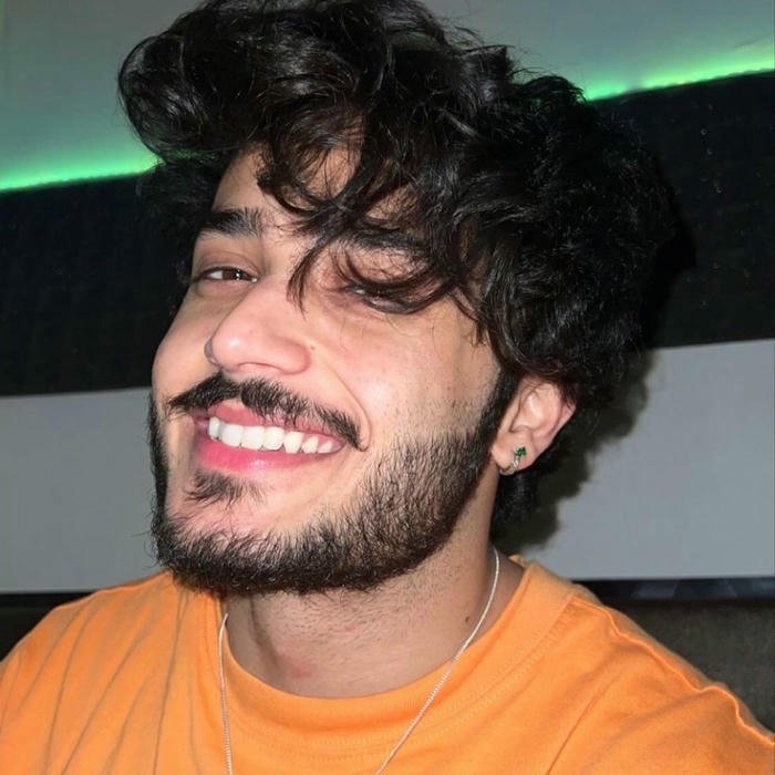 Happy guy smiling looking up with orange lighting effect