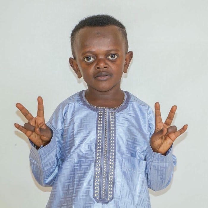 Little boy showing peace signs looking funny and cute