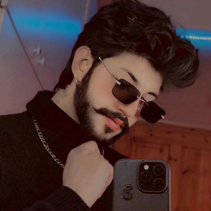 Man in car looking out window at golden sunset