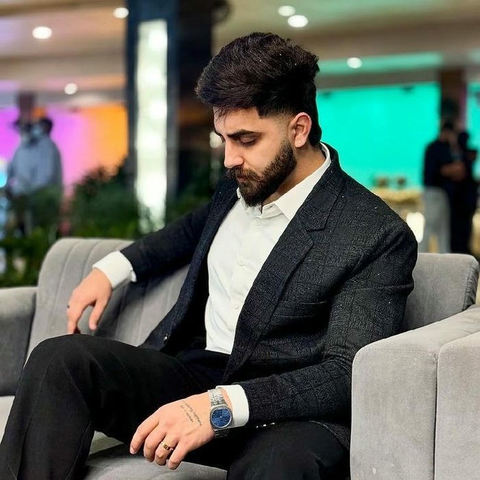 Punjabi boy dp classy man in suit sitting on sofa