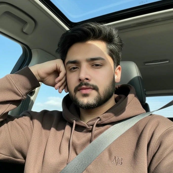 Punjabi boy dp man in brown hoodie sitting in car