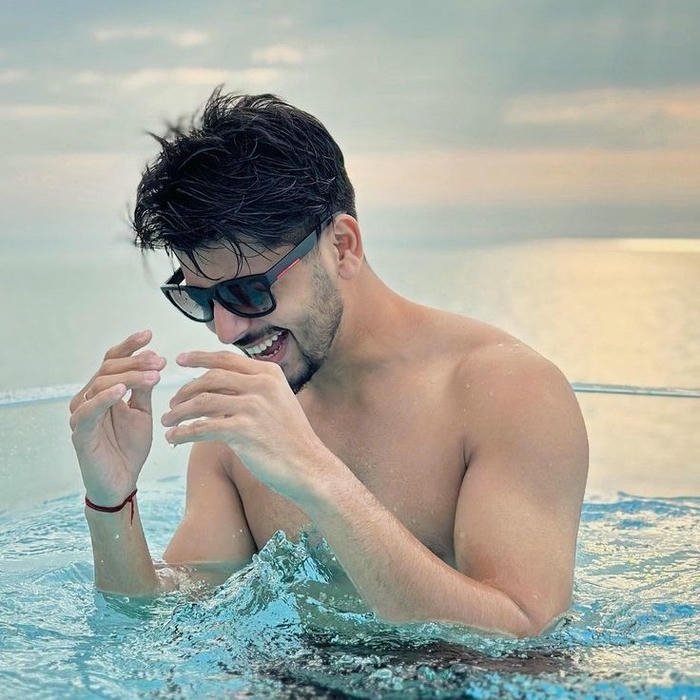Punjabi boy dp man in swimming pool looking cool wet