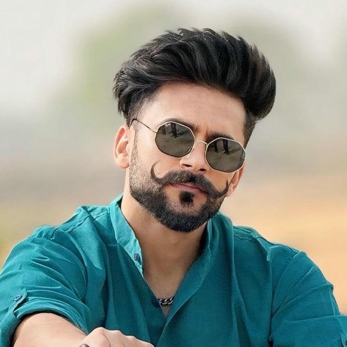 Punjabi boy dp man in teal shirt wearing sunglasses outdoors