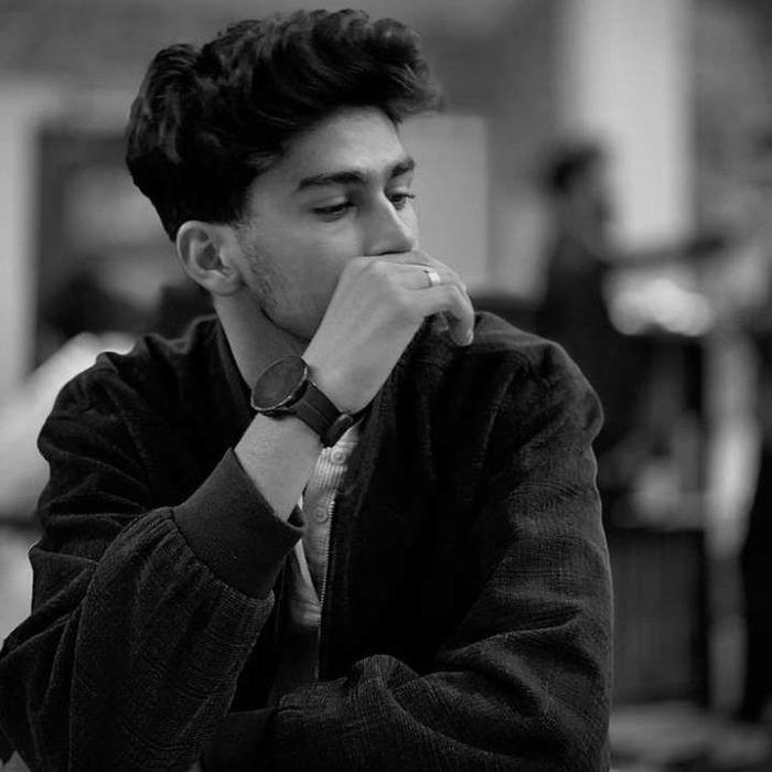 Real photo handsome boy looking sad and thoughtful outdoors