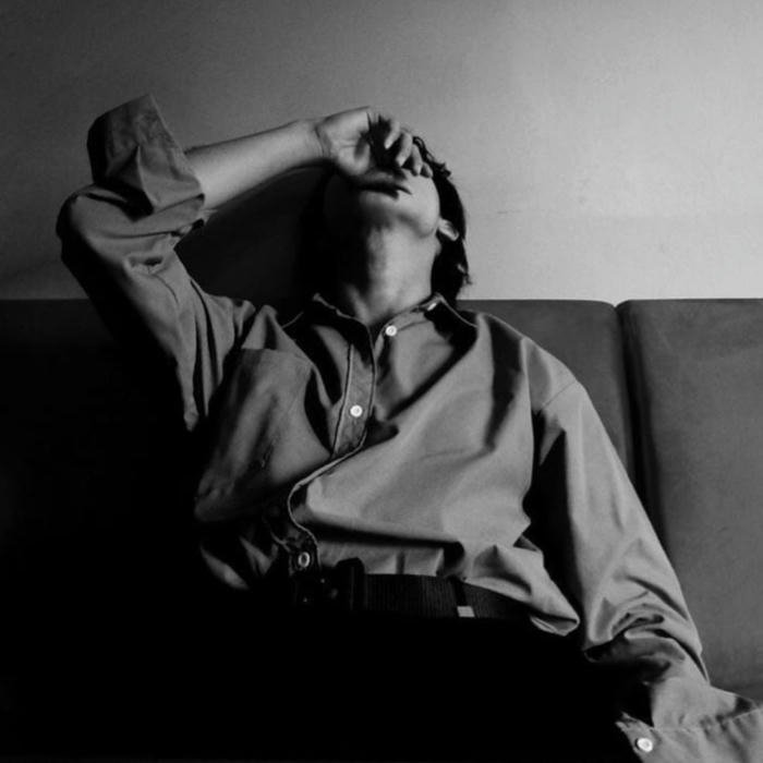 Sad boy dp hd man lying on couch covering face