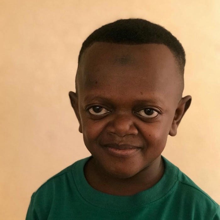 Small boy smiling looking at camera funny meme face