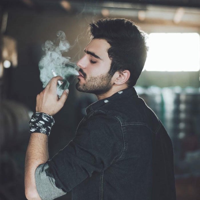 Smoker boy dp side view man exhaling smoke blue light