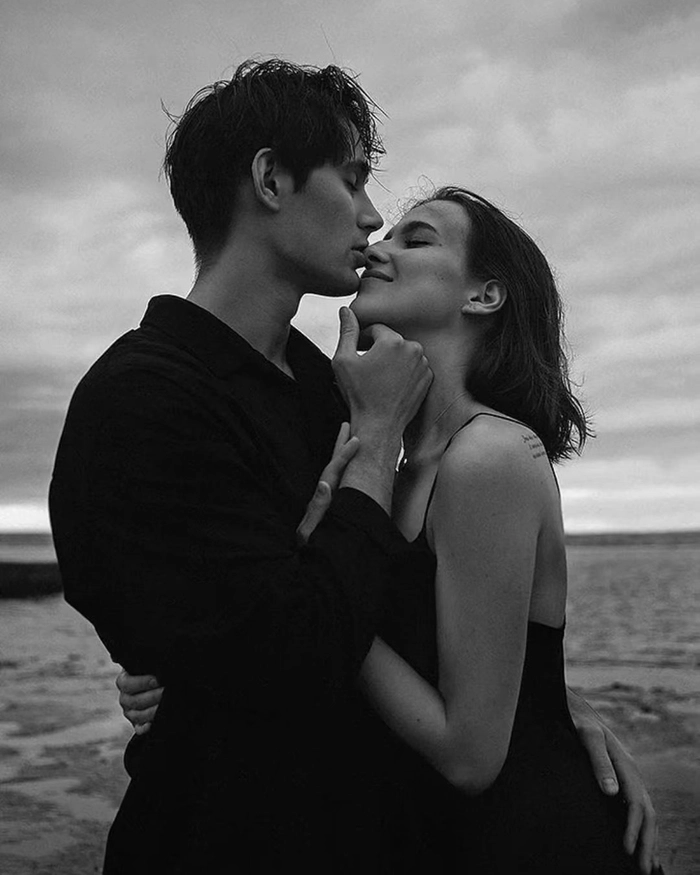 Romantic couple image showing soft emotional moment near ocean