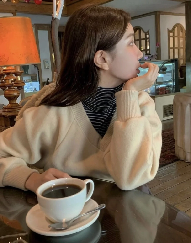 Relaxed bookstore mood with soft lighting cute girl with coffee cup dp